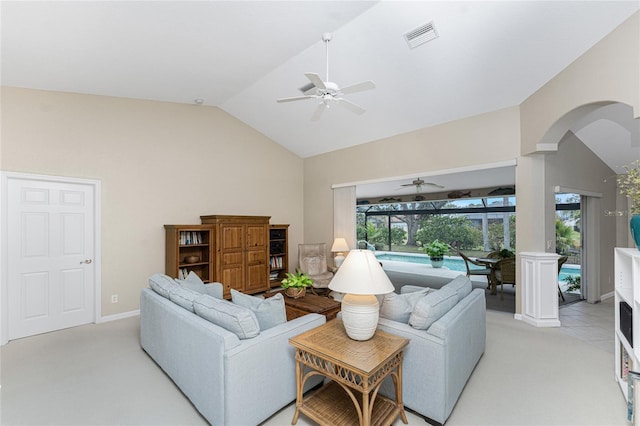 carpeted living room with ceiling fan, a healthy amount of sunlight, and lofted ceiling