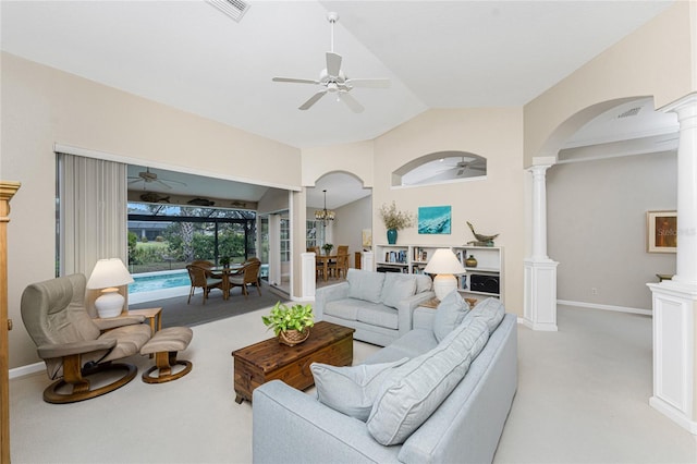 carpeted living room with decorative columns, ceiling fan, and vaulted ceiling