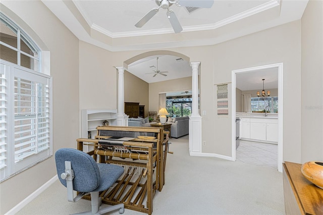 carpeted dining space with decorative columns, sink, a raised ceiling, ornamental molding, and ceiling fan