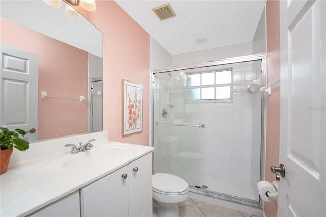 bathroom with toilet, vanity, an enclosed shower, and tile patterned flooring