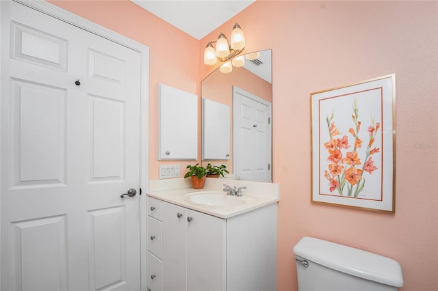 bathroom with toilet and vanity