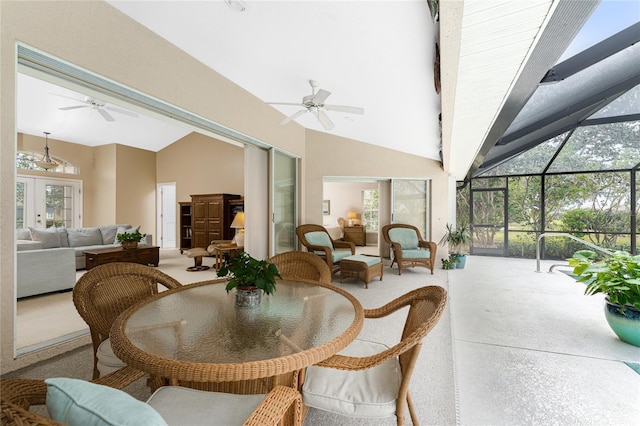 sunroom with ceiling fan, a healthy amount of sunlight, and lofted ceiling