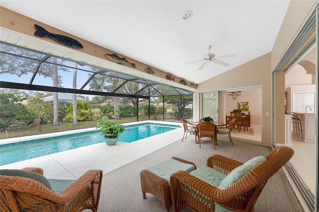 view of pool featuring glass enclosure, a bar, a patio, and ceiling fan