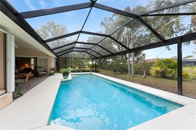 view of swimming pool with a patio and a lanai