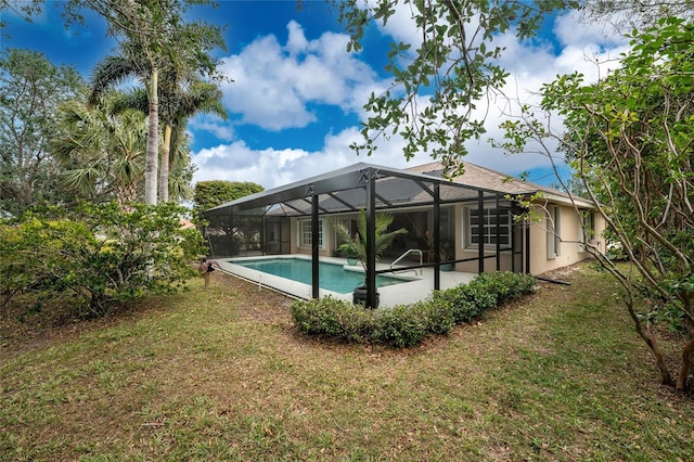 view of swimming pool with a patio area, a lanai, and a lawn