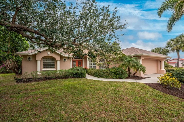 view of front of property with a front yard and a garage