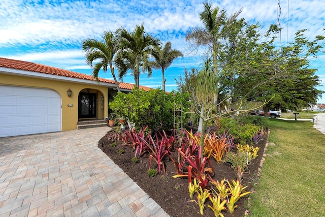 view of front of house with a garage and a front lawn