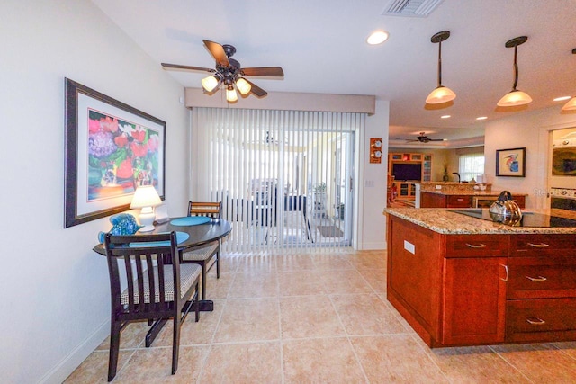 kitchen with hanging light fixtures, light tile patterned floors, black electric cooktop, ceiling fan, and light stone countertops