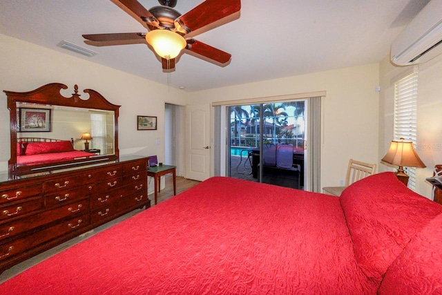 bedroom with ceiling fan, access to outside, multiple windows, and an AC wall unit