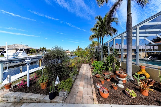 view of yard with a lanai and a boat dock