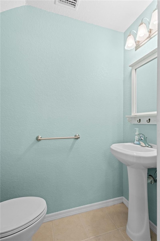 bathroom featuring sink, toilet, and tile patterned floors