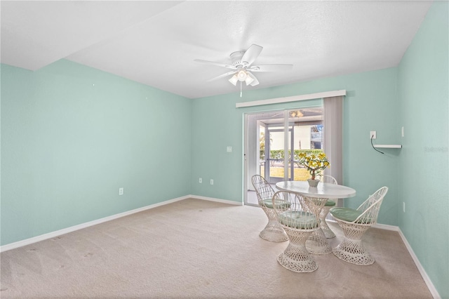 carpeted dining area featuring ceiling fan