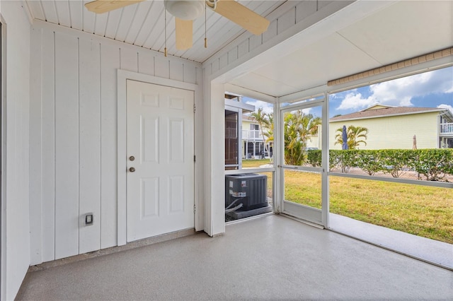 unfurnished sunroom featuring ceiling fan