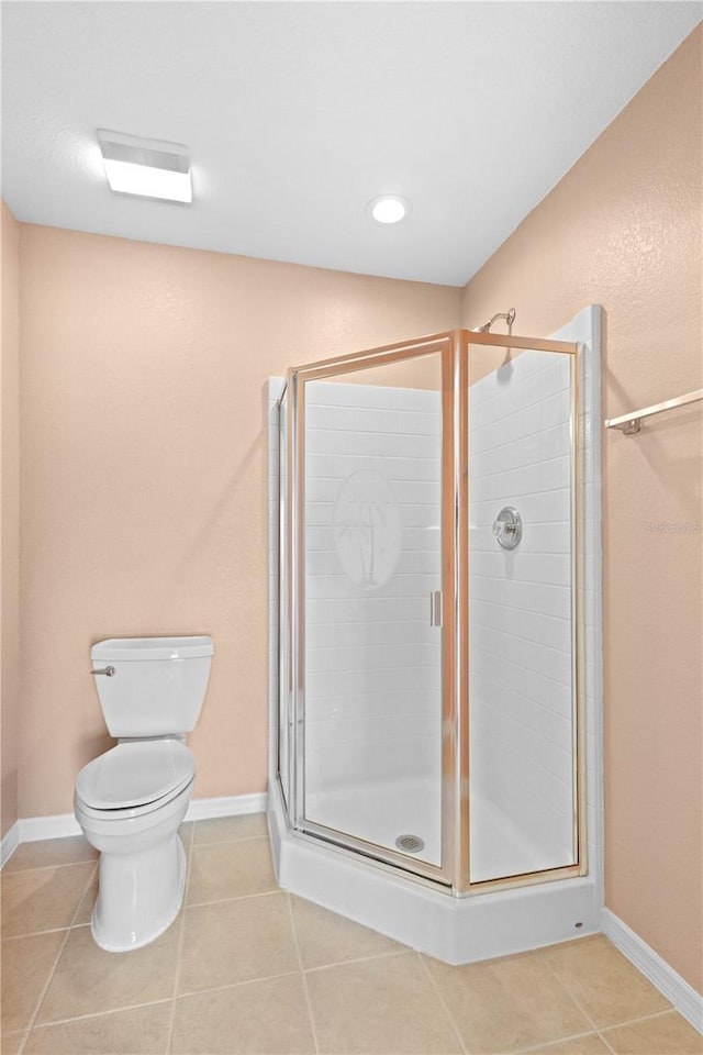 bathroom with toilet, tile patterned flooring, and an enclosed shower