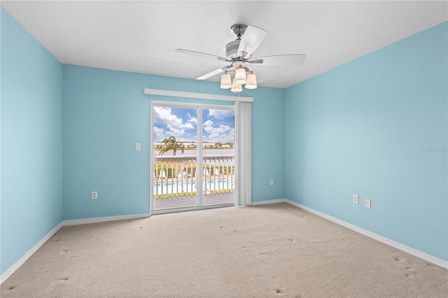 spare room featuring carpet floors and ceiling fan