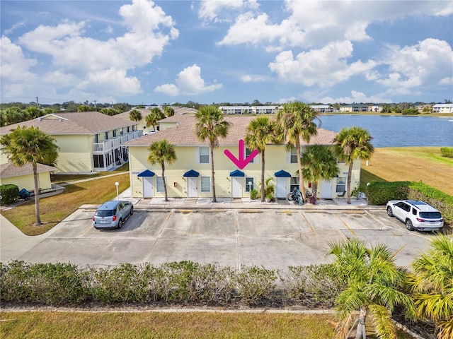 birds eye view of property with a water view