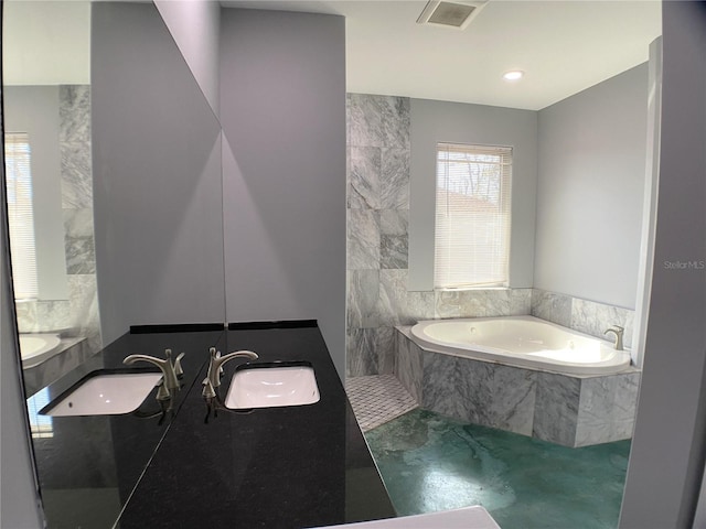 bathroom with vanity and a relaxing tiled tub