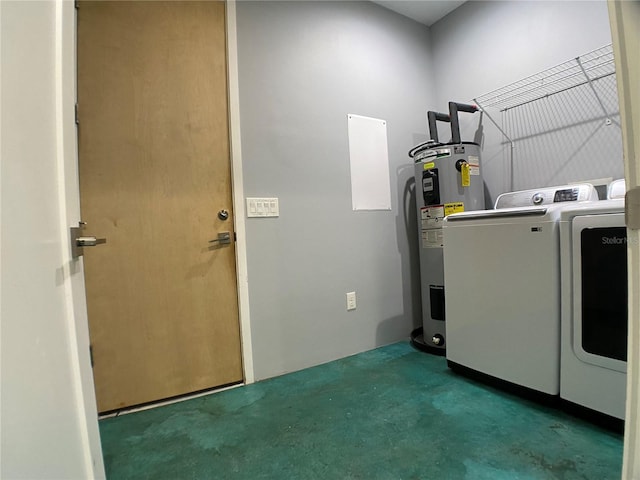 laundry room featuring washing machine and clothes dryer and electric water heater