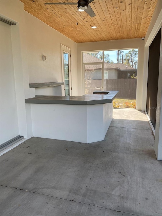 view of patio featuring a bar and ceiling fan