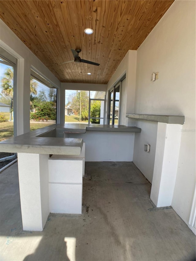 view of patio featuring an outdoor bar and ceiling fan