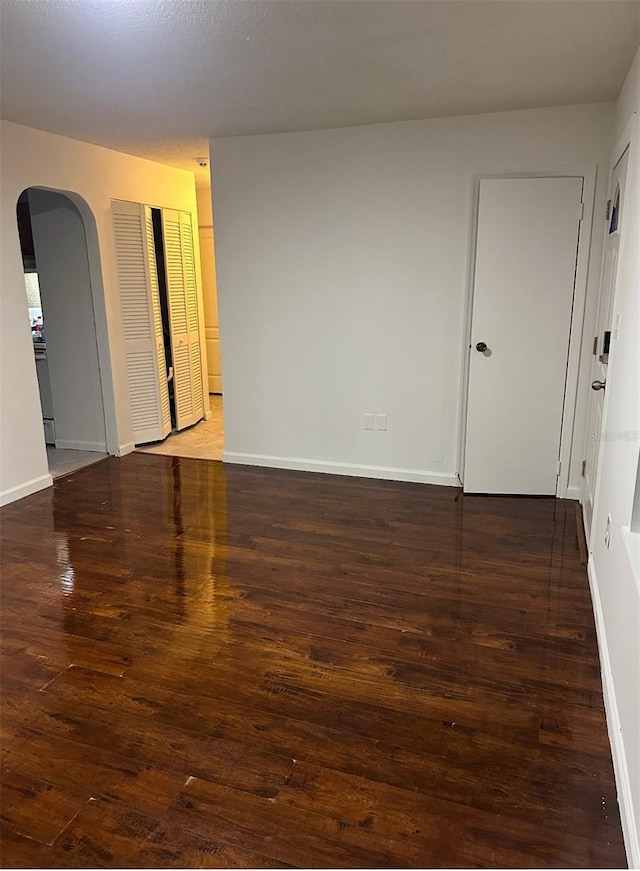 spare room featuring dark hardwood / wood-style floors