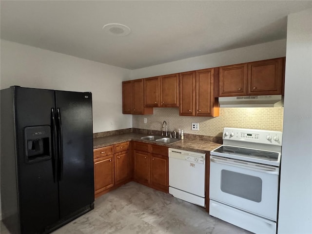 kitchen featuring sink, white appliances, and decorative backsplash