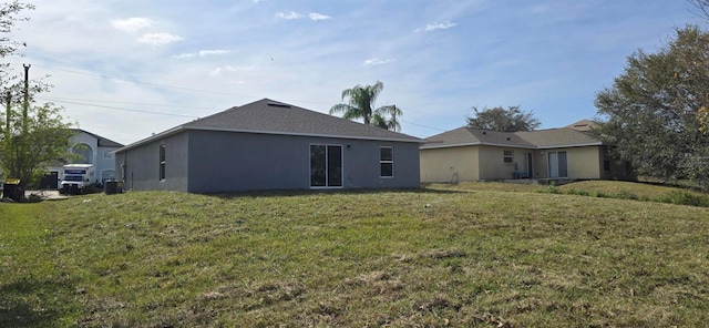 rear view of house featuring a lawn