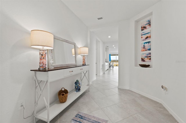 hall featuring light tile patterned floors