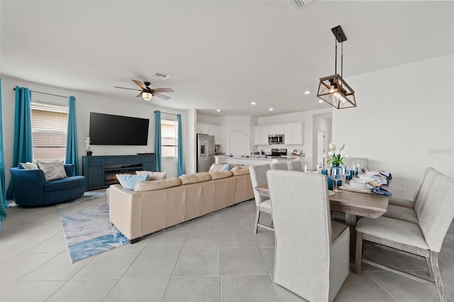 tiled dining area with ceiling fan