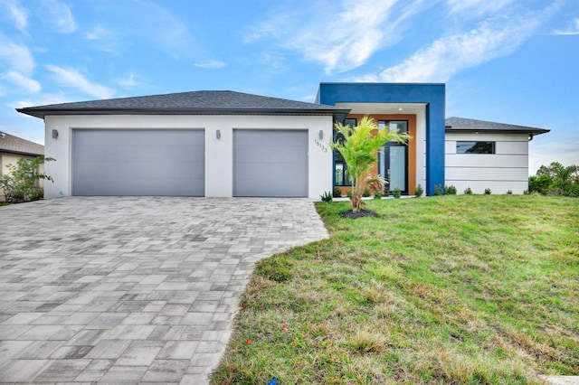 view of front of home with a front lawn and a garage