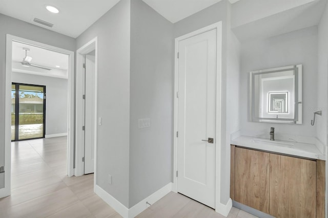 bathroom with ceiling fan and vanity