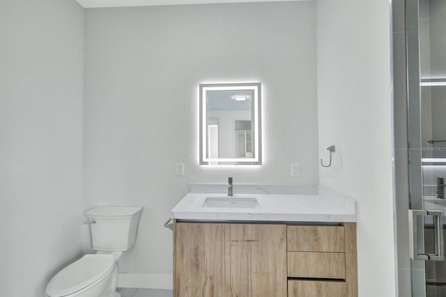 bathroom with toilet, tile patterned floors, and vanity