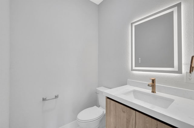 bathroom featuring toilet and vanity