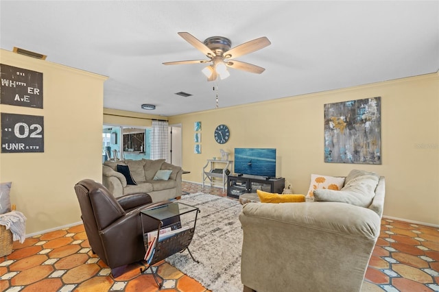 living room featuring ceiling fan and ornamental molding