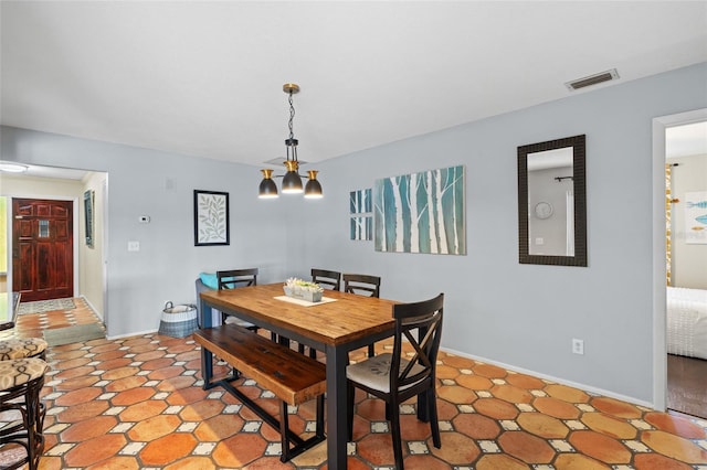 dining space featuring a notable chandelier