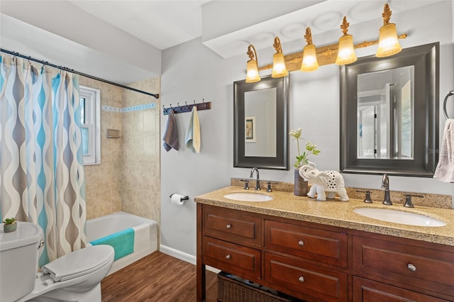 full bathroom with wood-type flooring, toilet, vanity, and shower / tub combo