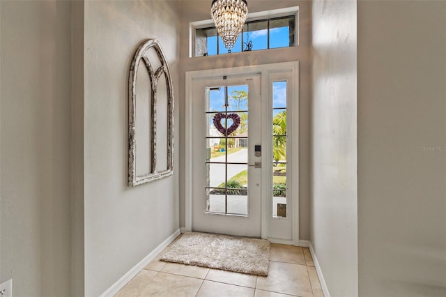 foyer with light tile patterned floors and a chandelier