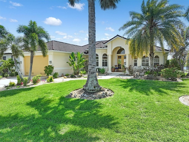 mediterranean / spanish-style home with a front lawn