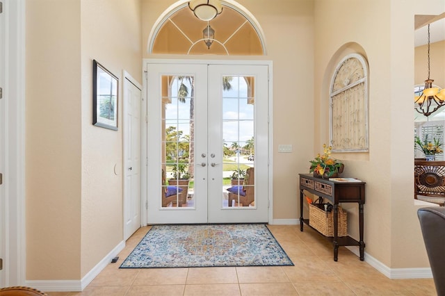 doorway to outside featuring light tile patterned floors and french doors