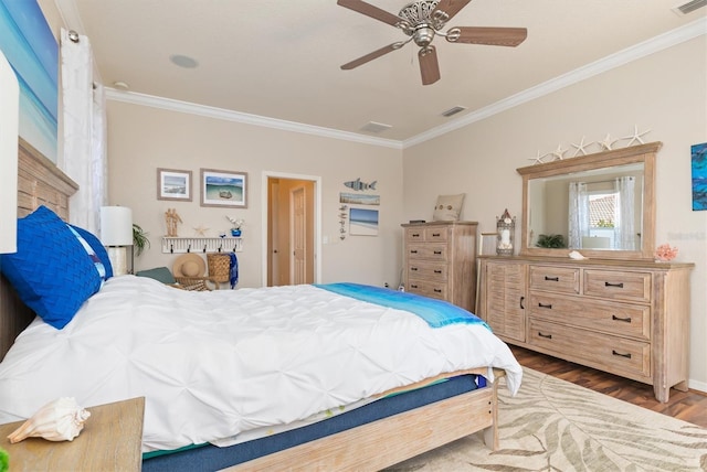 bedroom featuring ceiling fan, hardwood / wood-style flooring, and crown molding