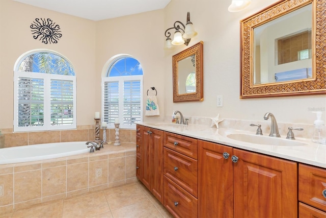 bathroom with tiled bath, tile patterned flooring, and vanity