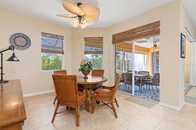 tiled dining room featuring ceiling fan and a healthy amount of sunlight