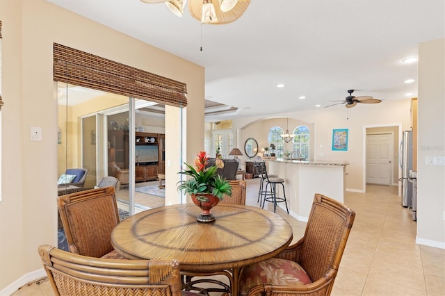 dining area with ceiling fan and light tile patterned floors