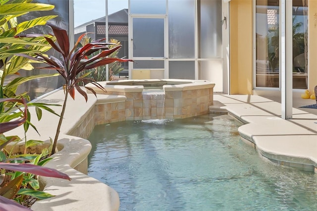 view of pool featuring pool water feature and an in ground hot tub