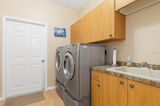 laundry room with cabinets, sink, light tile patterned floors, and independent washer and dryer