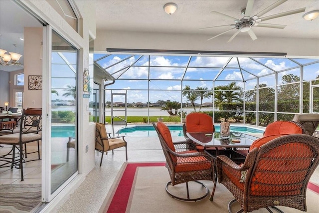 sunroom featuring ceiling fan, plenty of natural light, and a pool