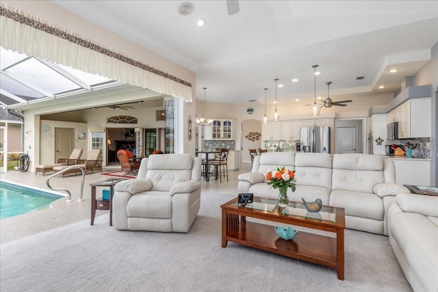 carpeted living room featuring ceiling fan