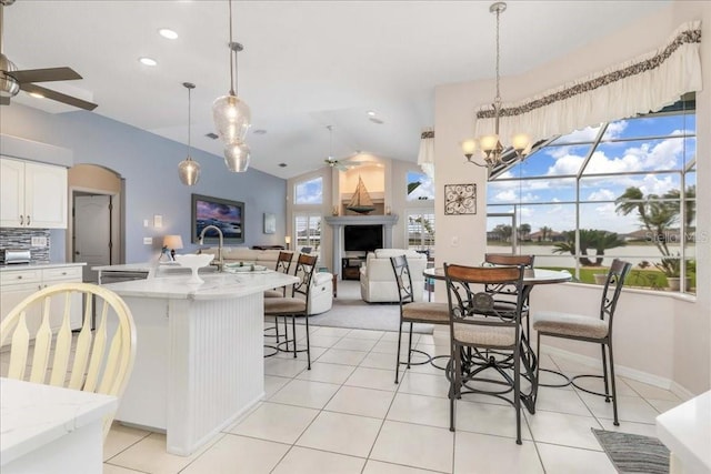 kitchen with white cabinets, plenty of natural light, ceiling fan with notable chandelier, and pendant lighting