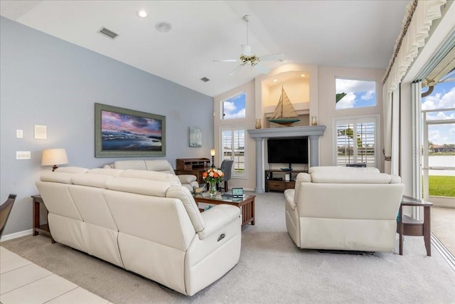 living room with ceiling fan, light colored carpet, and high vaulted ceiling