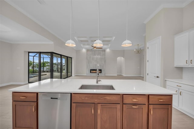 kitchen featuring pendant lighting, white cabinets, sink, and dishwasher